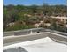 Backyard view from a rooftop patio featuring desert landscaping and a distant view of a golf course at 37445 N 104Th Pl, Scottsdale, AZ 85262