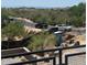 Scenic neighborhood view featuring lush desert vegetation, other houses, and distant mountains in the background at 37445 N 104Th Pl, Scottsdale, AZ 85262