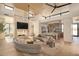 Spacious living area showcasing a modern curved sofa and kitchen at 28119 N 109Th Way, Scottsdale, AZ 85262