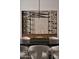 Modern dining room featuring a statement chandelier and built-in wine rack at 28101 N 109Th Way, Scottsdale, AZ 85262