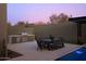 Outdoor kitchen with built-in grill and dining area at 28101 N 109Th Way, Scottsdale, AZ 85262