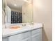 Clean bathroom featuring a white vanity with ample counter space and a large mirror reflecting natural light at 9143 W Harmony Ln, Peoria, AZ 85382