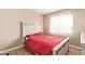 Bedroom showcasing a comfortable bed with red bedding and a large window providing plenty of natural light at 9143 W Harmony Ln, Peoria, AZ 85382