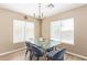 Dining room featuring a modern table and chairs, chandelier and natural light at 9143 W Harmony Ln, Peoria, AZ 85382