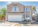 Two-story home featuring a two-car garage, desert landscaping and tile roof at 9143 W Harmony Ln, Peoria, AZ 85382