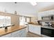 Bright, open kitchen with stainless steel appliances and adjacent dining area at 9143 W Harmony Ln, Peoria, AZ 85382