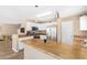 Open kitchen with white cabinetry, stainless steel appliances and center island at 9143 W Harmony Ln, Peoria, AZ 85382