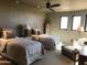 Bright bedroom with two beds, multiple windows for natural light, and ceiling fan at 11108 E Mariola Way, Scottsdale, AZ 85262