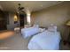 Charming bedroom featuring twin beds, ceiling fan, and elegant decor at 11108 E Mariola Way, Scottsdale, AZ 85262