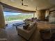 Open living area with comfortable seating, ceiling fan, and views of the outdoor landscape through expansive windows at 11108 E Mariola Way, Scottsdale, AZ 85262