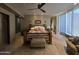 Cozy main bedroom featuring a ceiling fan, tile floors, and warm decor at 11108 E Mariola Way, Scottsdale, AZ 85262
