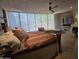 Well-lit main bedroom with a ceiling fan, fireplace and bright windows at 11108 E Mariola Way, Scottsdale, AZ 85262