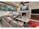 Spacious living room features a stone fireplace, large windows, and comfortable seating at 26761 N 98Th Way, Scottsdale, AZ 85262