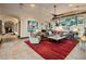 Comfortable living room with sectional sofa, large windows, and fireplace at 26761 N 98Th Way, Scottsdale, AZ 85262