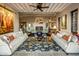 Living room with beamed ceiling, fireplace, and comfortable seating at 26761 N 98Th Way, Scottsdale, AZ 85262