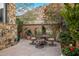 Charming patio with a table and chairs, surrounded by lush greenery at 26761 N 98Th Way, Scottsdale, AZ 85262