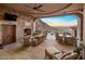Spacious stone patio with fireplace and seating area, mountain views at 26761 N 98Th Way, Scottsdale, AZ 85262