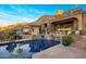 Large pool with waterfall feature and mountain backdrop at 26761 N 98Th Way, Scottsdale, AZ 85262