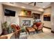 Cozy sitting area with fireplace and leather chairs at 26761 N 98Th Way, Scottsdale, AZ 85262