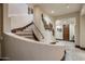 Curved staircase with stone steps and wrought iron railing at 26761 N 98Th Way, Scottsdale, AZ 85262