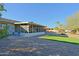 Backyard view showing a screened patio, gravel, and a patch of artificial turf at 17407 N 130Th Dr, Sun City West, AZ 85375