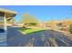 Artificial turf and gravel landscaping in a sunny backyard setting at 17407 N 130Th Dr, Sun City West, AZ 85375