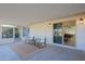 Relaxing covered patio with tile flooring and seating area, offering access to the interior at 17407 N 130Th Dr, Sun City West, AZ 85375