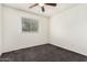 Bedroom with neutral carpet, window, and ceiling fan at 1673 W Hazelwood St, Phoenix, AZ 85015