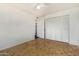 This bedroom features hardwood floors, a ceiling fan, and a closet at 1673 W Hazelwood St, Phoenix, AZ 85015