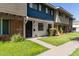 Inviting townhome displaying a neat front lawn with a walkway that leads to the black front door at 1673 W Hazelwood St, Phoenix, AZ 85015