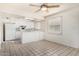 Sunny open-plan kitchen with white cabinets, appliances and tiled floor, perfect for cooking at 1673 W Hazelwood St, Phoenix, AZ 85015