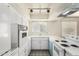 Classic kitchen featuring white appliances, a bright window, and ample counter space for meal prep at 1673 W Hazelwood St, Phoenix, AZ 85015