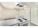 Bright kitchen featuring a white electric stove, oven, and exhaust hood at 1673 W Hazelwood St, Phoenix, AZ 85015
