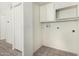 Bright laundry room with tile flooring, washer and dryer hookups, and storage cabinets at 1673 W Hazelwood St, Phoenix, AZ 85015