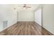 Bright living room with wood flooring and a ceiling fan at 1673 W Hazelwood St, Phoenix, AZ 85015
