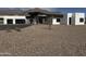 Modern home with a large garage and desert landscaping under a blue sky at 3525 S Kings Ranch Ct # 4, Gold Canyon, AZ 85118