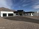 Modern home with a black garage door, desert landscaping and mountain views at 3525 S Kings Ranch Ct # 4, Gold Canyon, AZ 85118