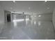 Spacious garage interior with epoxy floors, modern lighting, and large doors at 3525 S Kings Ranch Ct # 4, Gold Canyon, AZ 85118