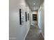 Long hallway with gray walls and tile floors at 3525 S Kings Ranch Ct # 4, Gold Canyon, AZ 85118