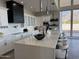 Modern kitchen features white cabinets, quartz countertops, and a large island at 3525 S Kings Ranch Ct # 4, Gold Canyon, AZ 85118