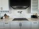 Modern kitchen featuring white cabinets, quartz countertops, an induction cooktop, and a pot filler at 3525 S Kings Ranch Ct # 4, Gold Canyon, AZ 85118