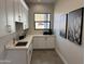 Well-appointed laundry room with sink and ample cabinetry at 3525 S Kings Ranch Ct # 4, Gold Canyon, AZ 85118