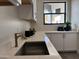 Laundry room featuring white cabinets, stone countertops, and stainless steel sink at 3525 S Kings Ranch Ct # 4, Gold Canyon, AZ 85118