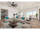 Spacious living room featuring comfortable seating, ample natural light, and access to the kitchen at 31712 N 169Th Ave, Surprise, AZ 85387