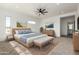 Bright main bedroom featuring a neutral palette, plush rug, and views from the windows at 31712 N 169Th Ave, Surprise, AZ 85387