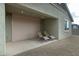 Covered patio with roll-up door and lounge chairs at 12200 E Chevelon Trl, Gold Canyon, AZ 85118