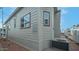 Side view of a light beige mobile home with windows and AC unit at 724 Emerald Dr, Apache Junction, AZ 85119