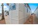 Side view of a light beige mobile home with access panel and gravel at 724 Emerald Dr, Apache Junction, AZ 85119
