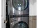Modern laundry room with stacked washer and dryer at 724 Emerald Dr, Apache Junction, AZ 85119