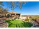 House exterior and backyard with a grassy area and pool at 9025 N Flying Butte --, Fountain Hills, AZ 85268